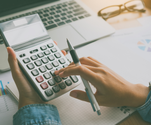 Person with a calculator in hand