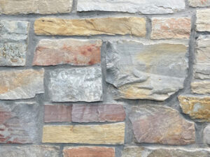 closeup of chilton rustic natural stone veneer display with standard grey mortar