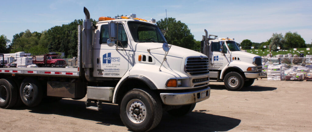 photo of hedberg flatbed trucks parked and waiting to be loaded