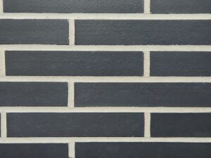 Manganese norman brick product swatch with white mortar