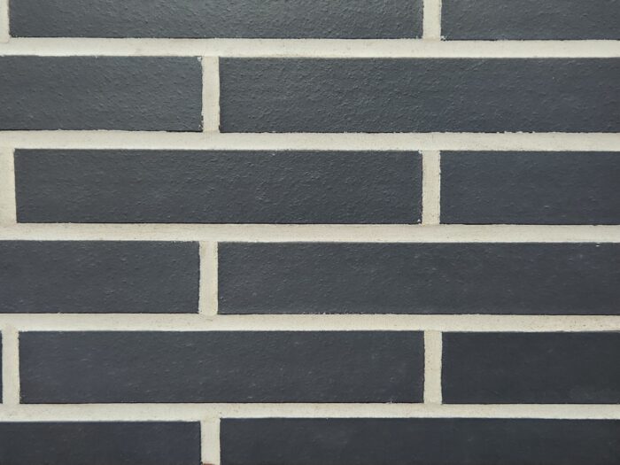 Manganese norman brick product swatch with white mortar