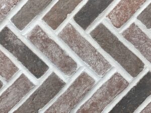 Noble Red Clay Thin Brick Herringbone on Mesh