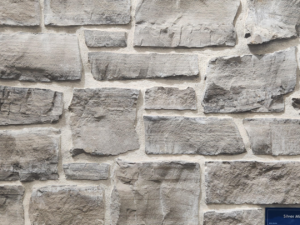 closeup of silver mist natural stone veneer display with white mortar