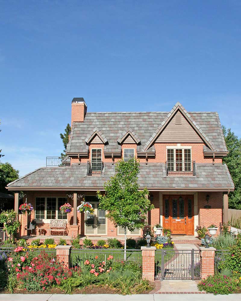 craftsman inspired house with pink summit brick exterior and cottage garden landscape