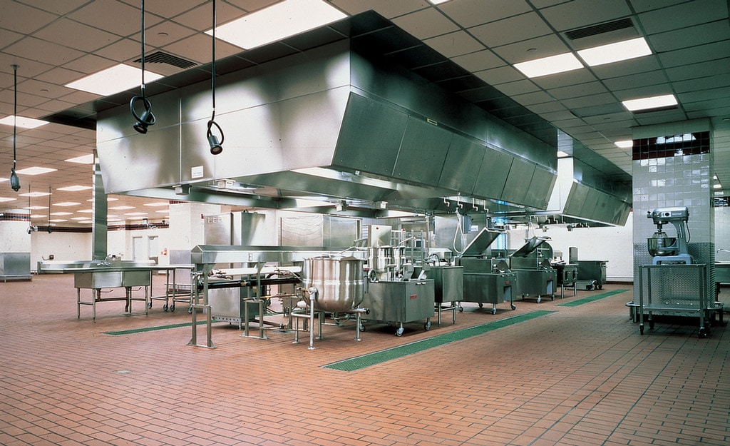 empty commercial kitchen with stainless steel equipment and summitville brick flooring