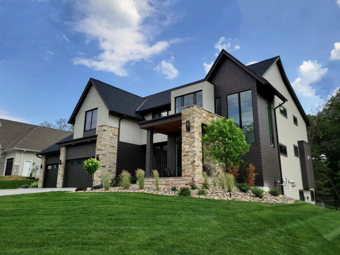 modern residential home with cream and honey toned stone pillars