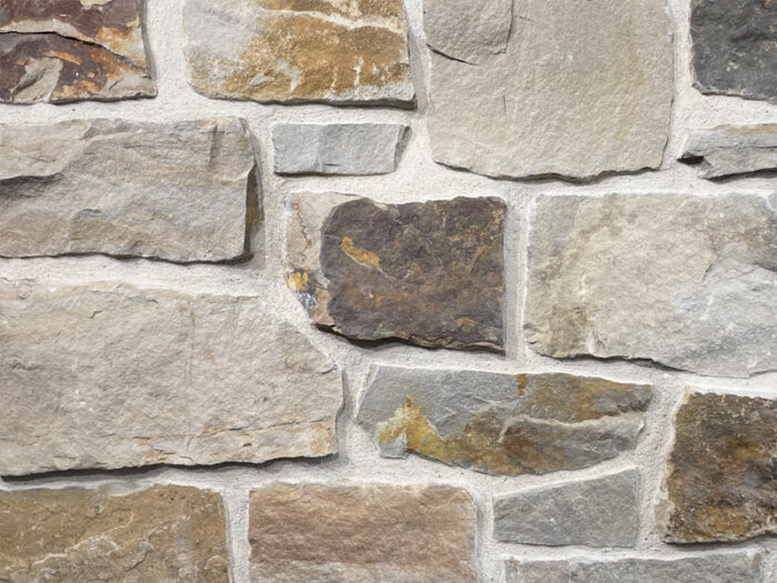 closeup of alta smear natural stone veneer display with white mortar
