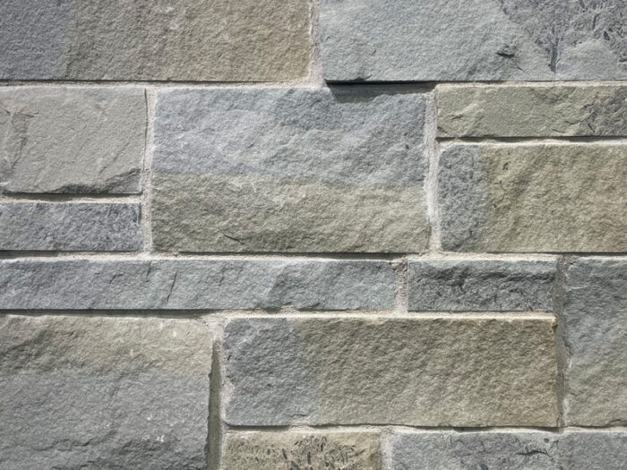 closeup of bluestone tailored blend natural stone veneer display with white mortar