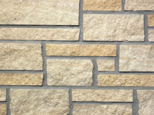 closeup of champagne plains natural stone veneer display with standard grey mortar