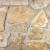closeup of chestnut boulder natural stone veneer display with standard grey mortar
