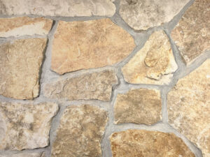 closeup of chestnut boulder natural stone veneer display with standard grey mortar