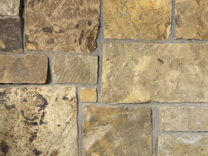 closeup of chestnut hill castle rock natural stone veneer display with standard grey mortar