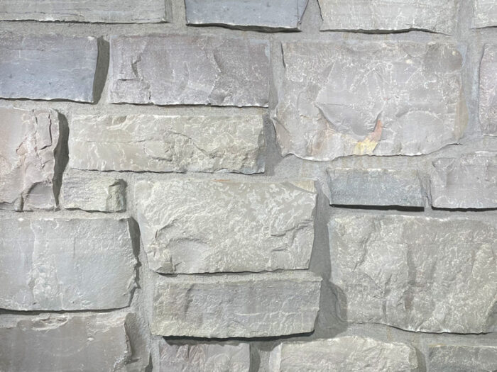 closeup of chilton country squire natural stone veneer display with standard grey mortar