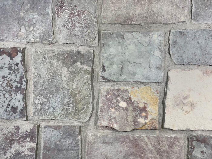 closeup of chilton castle rock natural stone veneer display with standard grey mortar