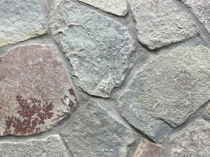 closeup of chilton web wall natural stone veneer display with standard grey mortar