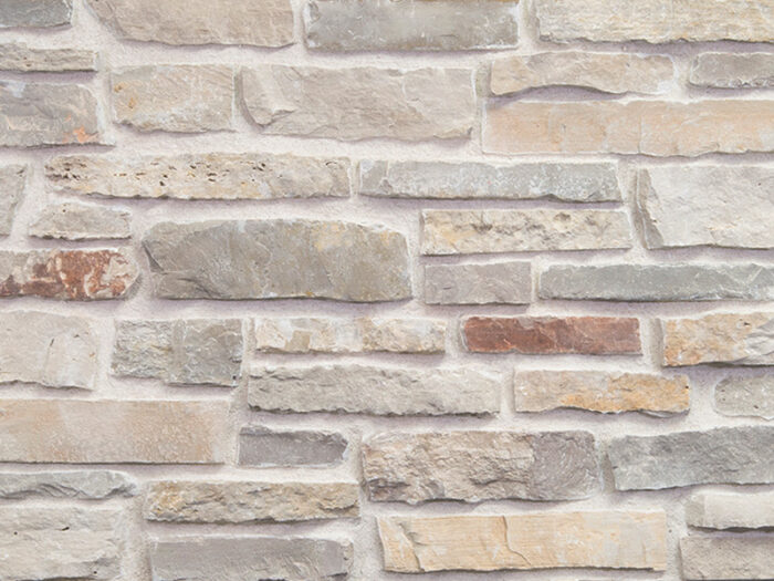 closeup of cottage garden natural stone veneer display with standard grey mortar