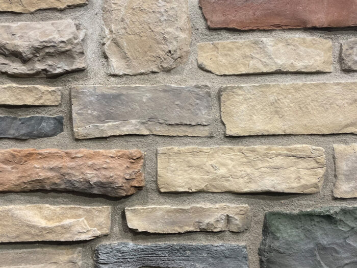 closeup of cumberland ridge manufactured stone veneer display with standard grey mortar
