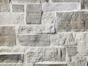 closeup of door county farmhouse natural stone veneer display with white mortar