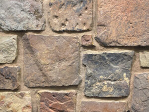 closeup of fieldstone squares and recs natural stone veneer display with buff mortar