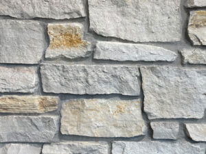 closeup of fond du lac cambrian natural stone veneer display with standard grey mortar