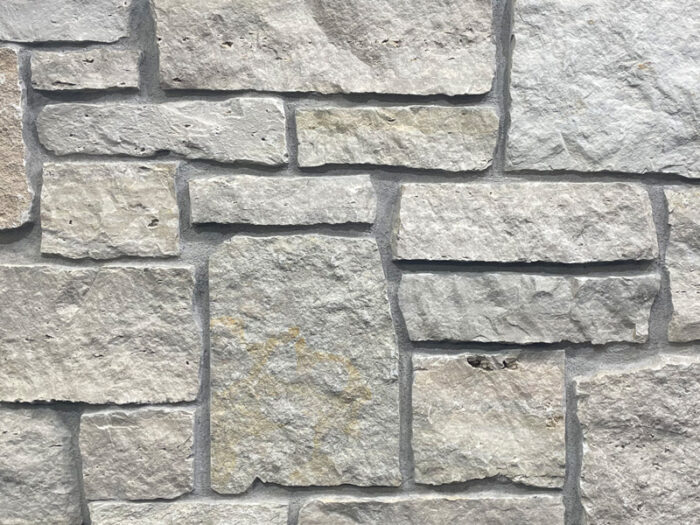 closeup of fond du lac kensington natural stone veneer display with standard grey mortar