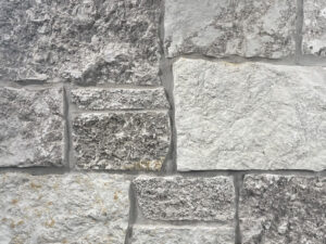 closeup of hamilton gray castle rock natural stone veneer display with standard grey mortar