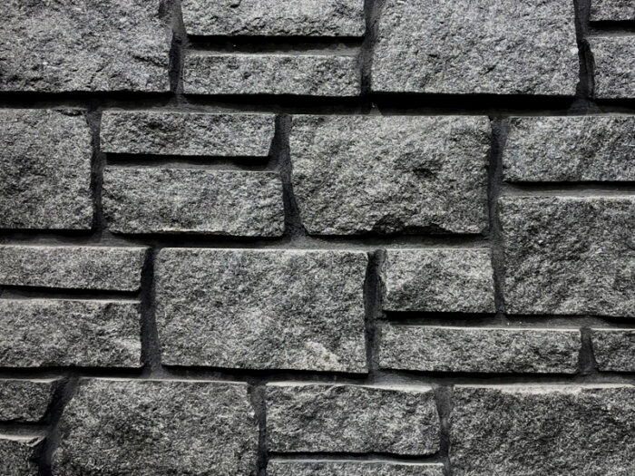 closeup of headwaters charcoal natural stone veneer display with 97H super black mortar