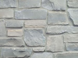 closeup of charcoal country squire natural stone veneer display with standard grey mortar