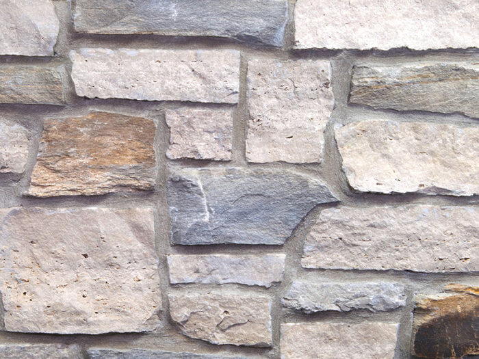 closeup of mystic cavern natural stone veneer display with standard grey mortar