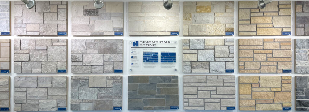 large showroom wall covered floor to ceiling in oversized displays of natural stone veneer in varying colors and styles