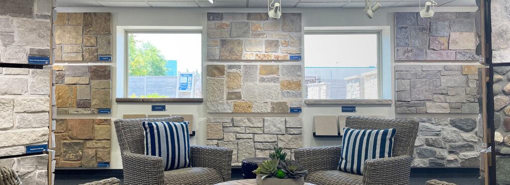 showroom interior with seating area and oversized displays of natural stone veneer in varying colors and profiles