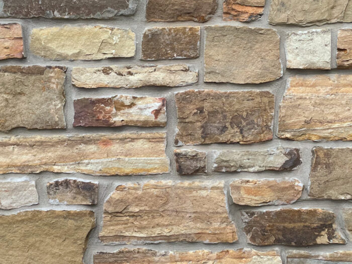 closeup of juniper ridge natural stone veneer display with standard grey mortar