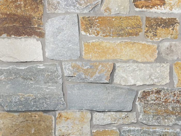 closeup of mcgregor lake ledge natural stone veneer display with standard grey mortar