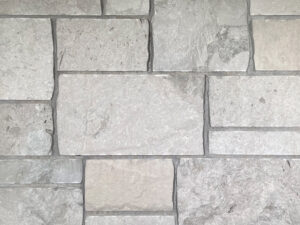 closeup of middleton castle natural stone veneer display with standard grey mortar