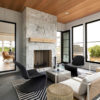modern sunroom featuring a white stone fireplace