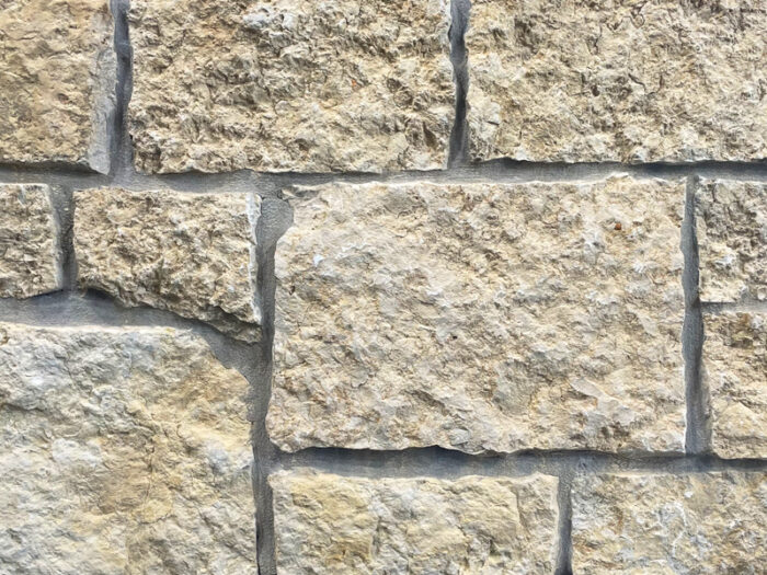 closeup of mill creek castle rock natural stone veneer display with white mortar