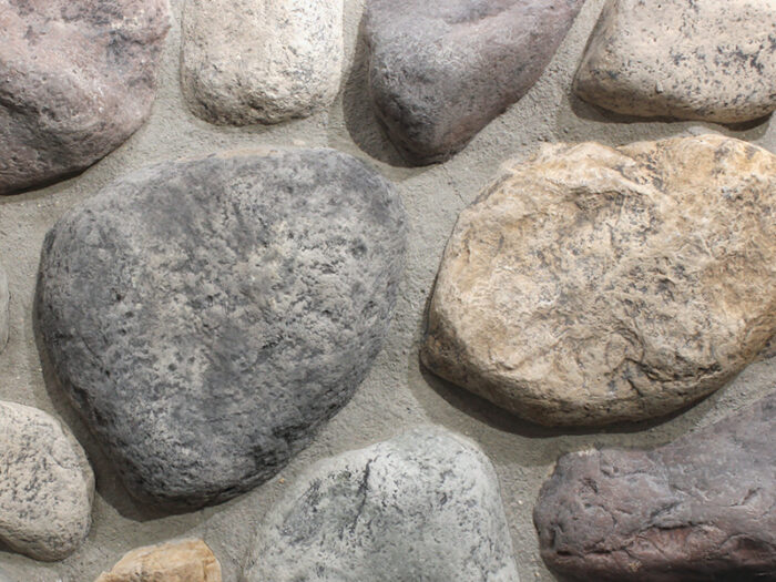 closeup of minnesota fieldstone blend manufactured stone veneer display with standard grey mortar