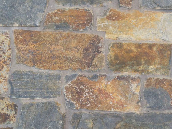 closeup of montana antique ledge natural stone veneer display with standard grey mortar