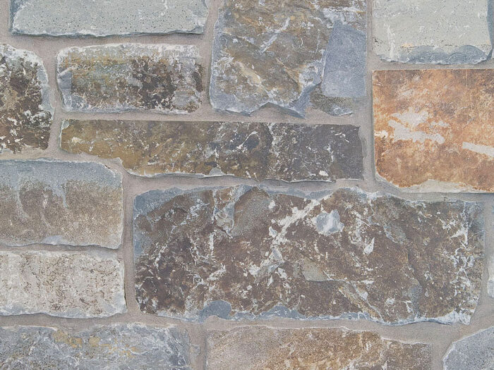 closeup of moose mountain ledge natural stone veneer display with standard grey mortar