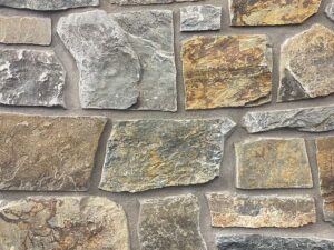 closeup of mountain lodge natural stone veneer display with standard grey mortar