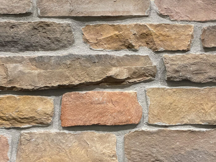 closeup of napa valley ridge manufactured stone veneer display with standard grey mortar