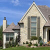 traditional home with cream-colored natural stone feature wall on the main facade