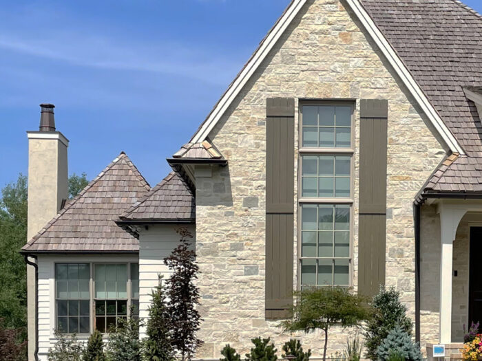 traditional home with cream-colored natural stone feature wall on the main facade