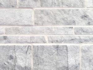 closeup of pacific white marble natural stone veneer display with white mortar