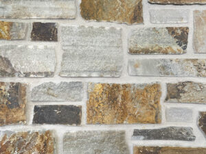 closeup of perma gold natural stone veneer display with white mortar