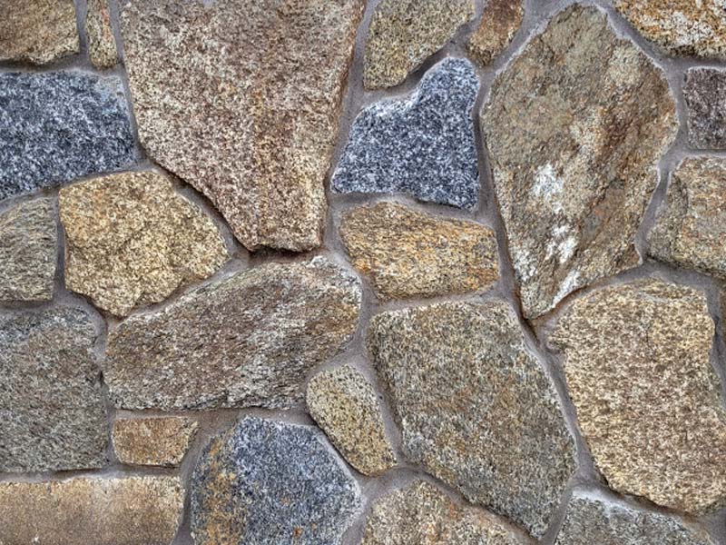 closeup of piedmont granite natural stone veneer display with standard gray mortar