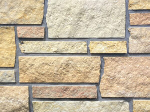 closeup of prairie blend natural stone veneer display with standard grey mortar