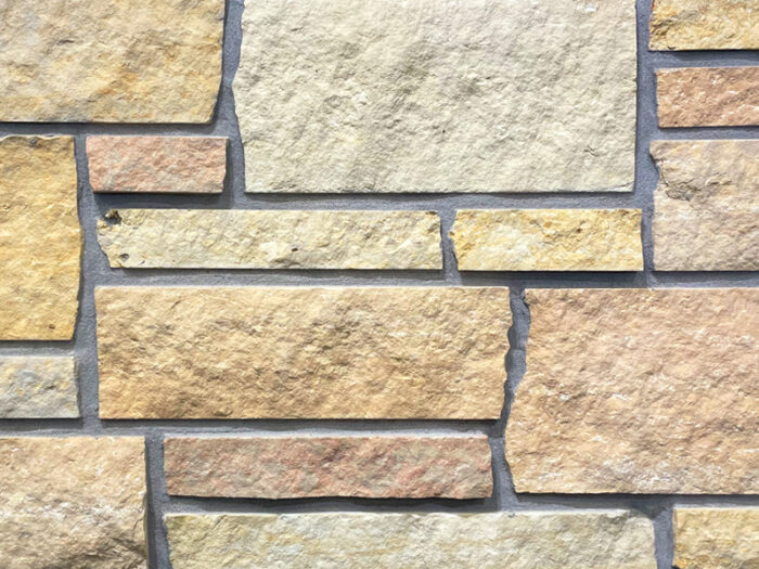 closeup of prairie blend natural stone veneer display with standard grey mortar