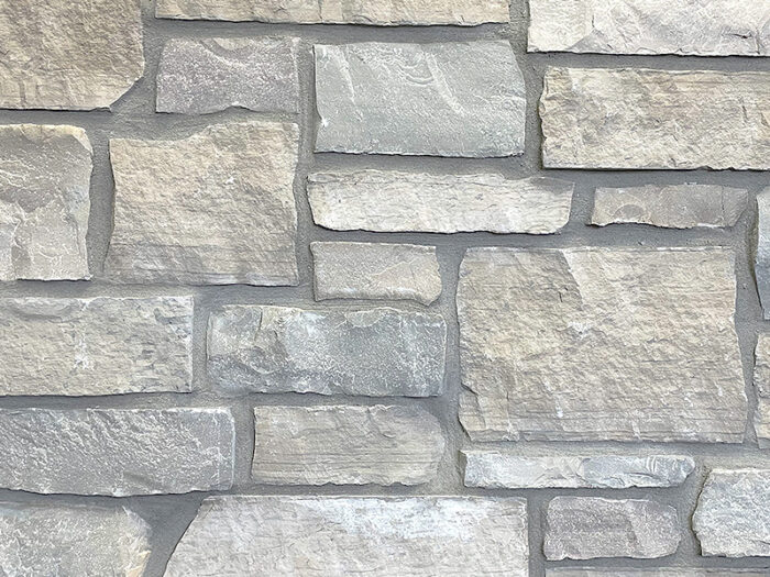 closeup of prairie dusk two natural stone veneer display with standard grey mortar