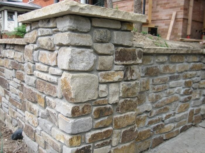 natural stone landscape wall with colors ranging from light buffs to brown and gold
